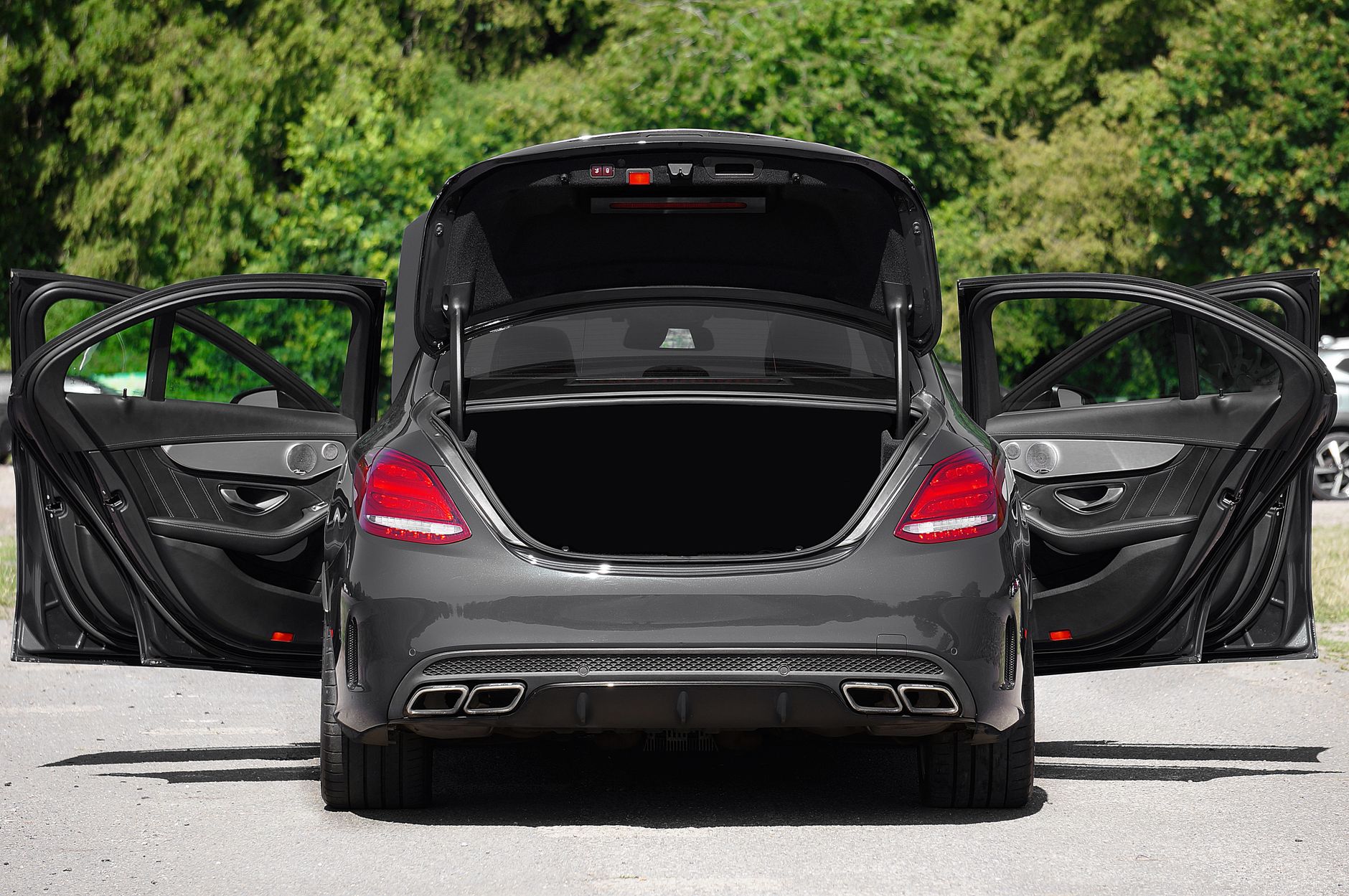 A luxury car with all doors and trunk open, showcasing elegant design and spacious interior.