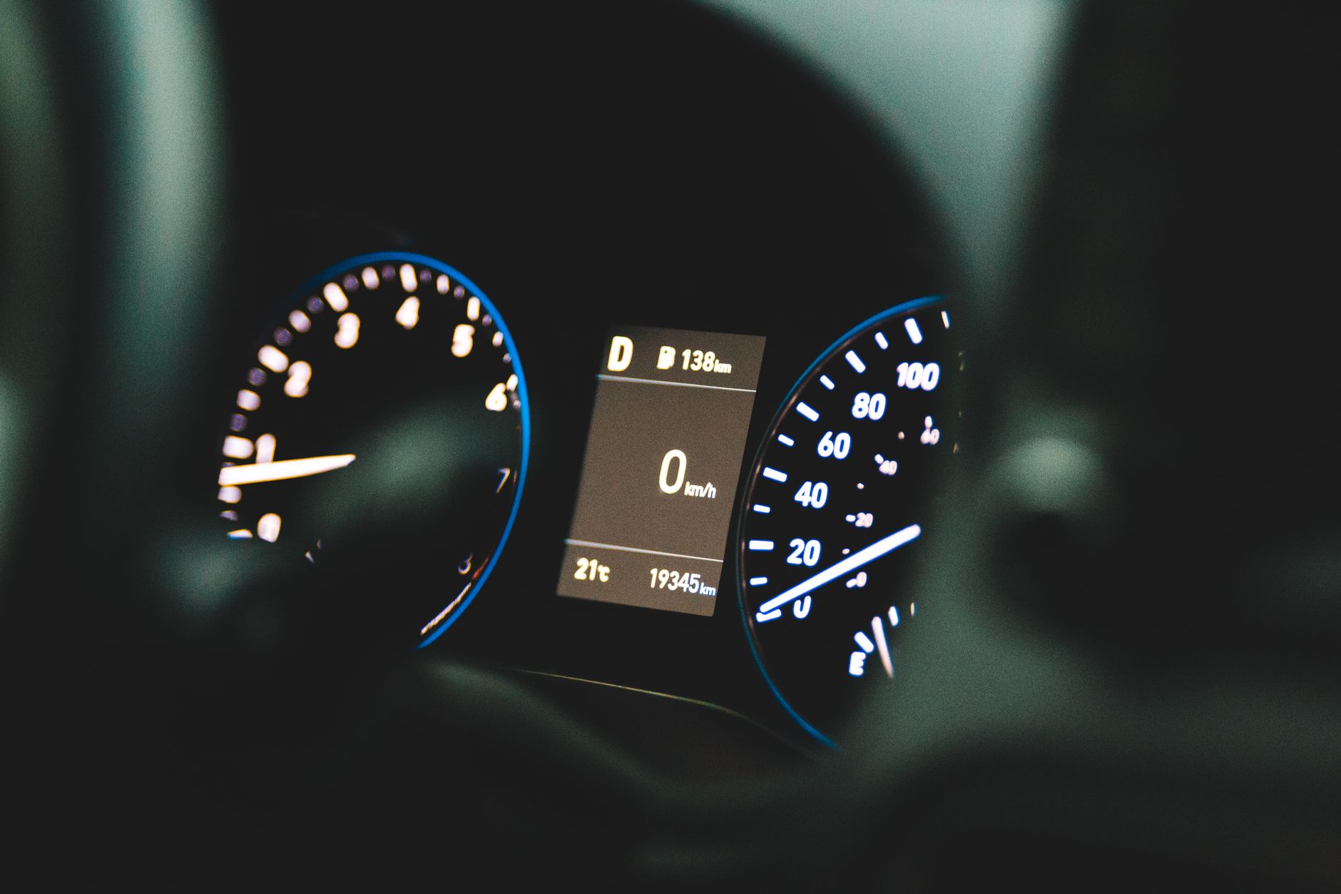 A detailed view of a car's dashboard display showing zero speed and odometer reading of 19345 km.