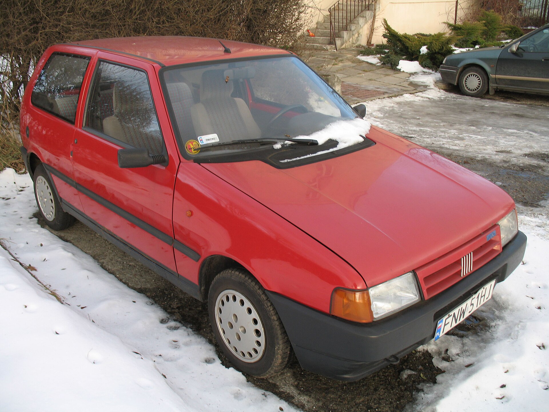 Red Fiat Uno 1.0 i.e. Mk2 3-door car in Kraków, Poland. Imported from Germany.
