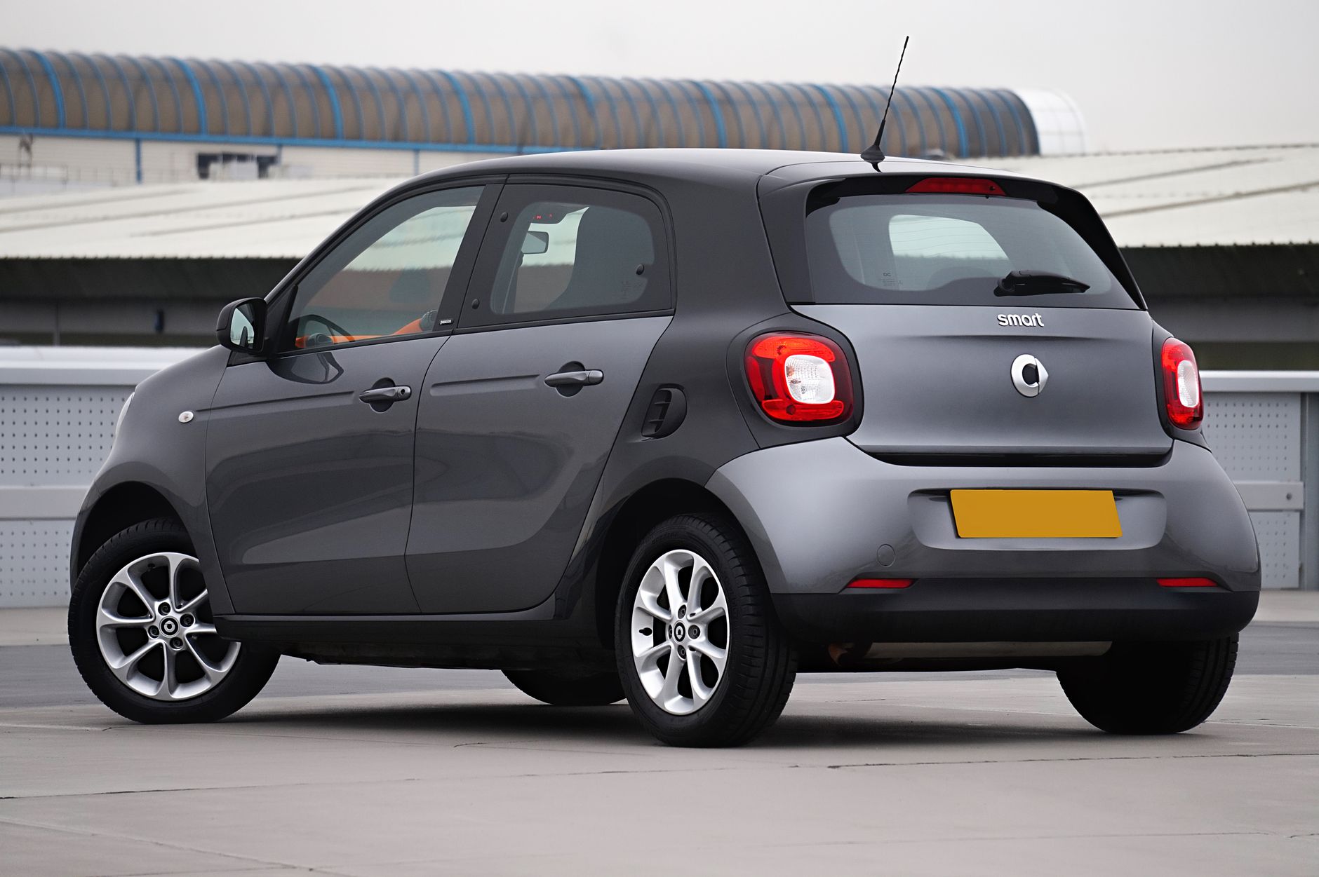 Gray Smart Forfour viewed from behind in a modern urban environment.
